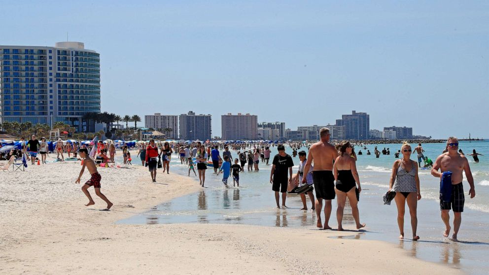 PHOTO: CLEARWATER, FL - MARCH 18: People gather on Clearwater Beach during spring break despite world health officials' warnings to avoid large groups on March 18, 2020 in Clearwater, Florida.