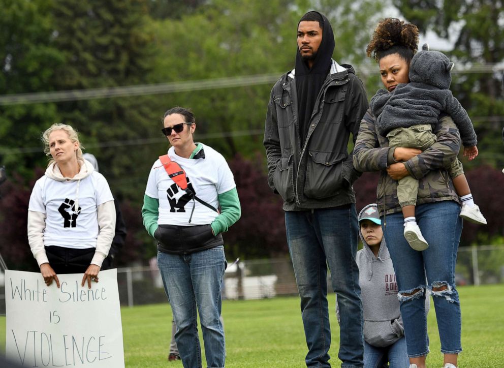 PHOTO: Jeramy Hughes stands next to Shayla Skinner, holding her son J'Kai Skinner, 2, during a remembrance in Coeur d'Alene, Idaho, June 7, 2020, for George Floyd.
