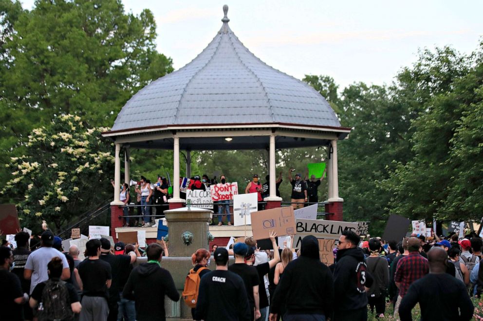 PHOTO: Protesters hold signs at a rally at a park in Lawrence, Kan., May 31, 2020, over the death of George Floyd.