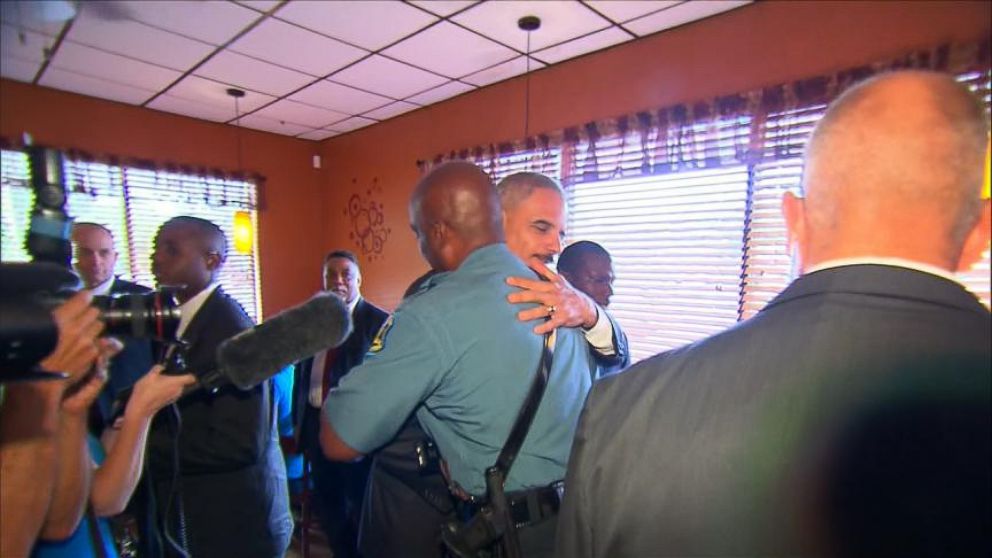 Attorney General Eric Holder greets Captain Ron Johnson in Ferguson, Mo., Aug. 20, 2014.