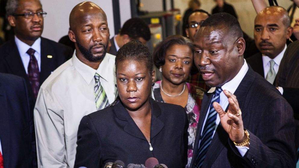 PHOTO: Sybrina Fulton (C) and Tracy Martin (L), parents of Trayvon Martin, listen while their friend and lawyer Benjamin Crump speaks to the press after a forum of Democratic members of the House Judiciary Committee on Capitol Hill March 27, 2012.