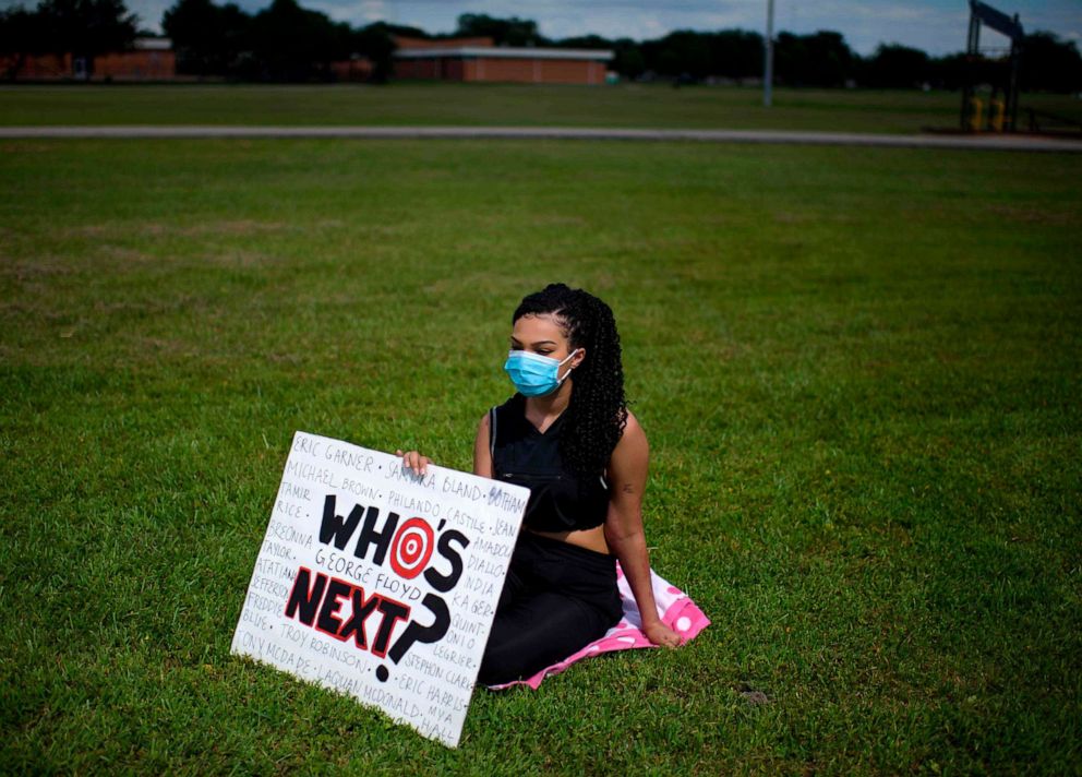 PHOTO: A woman holds a sign at a Sit In Protest to mourn the death of George Floyd at DeepWater Park, in Pasadena, Texas, on June 7, 2020.