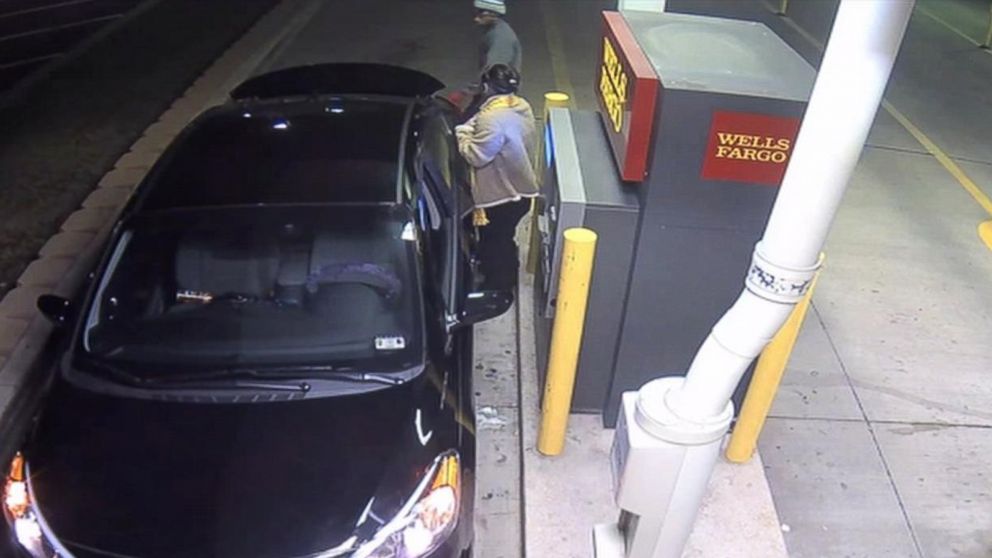 PHOTO: Surveillance footage shows a woman being approached by an armed suspect at a bank in Arlington, Texas, Jan. 14, 2015. 