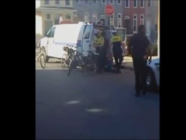 VIDEO: Shaky cell phone video appears to show officers surrounding Gray, 25, during his arrest in Baltimore in April. Gray died while in police custody.