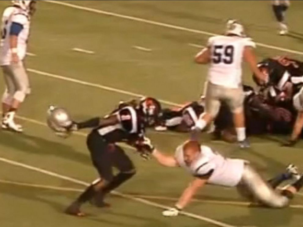 brown football player hits with helmet Football Player Hits Opponent With Helmet During High School Game