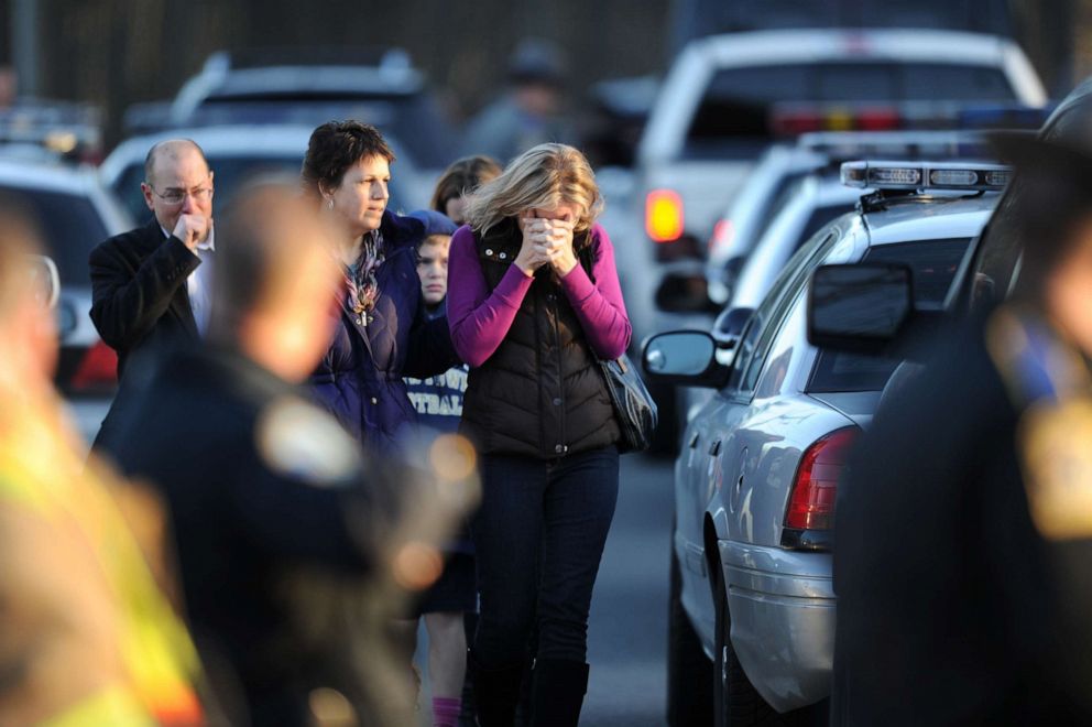 PHOTO: Residents grieve following a shooting on Dec. 14, 2012 at Sandy Hook Elementary School on Dec. 14, 2012 in Newtown, Conn., where at least 26 people, including 20 young children, were killed when a gunman assaulted the school.