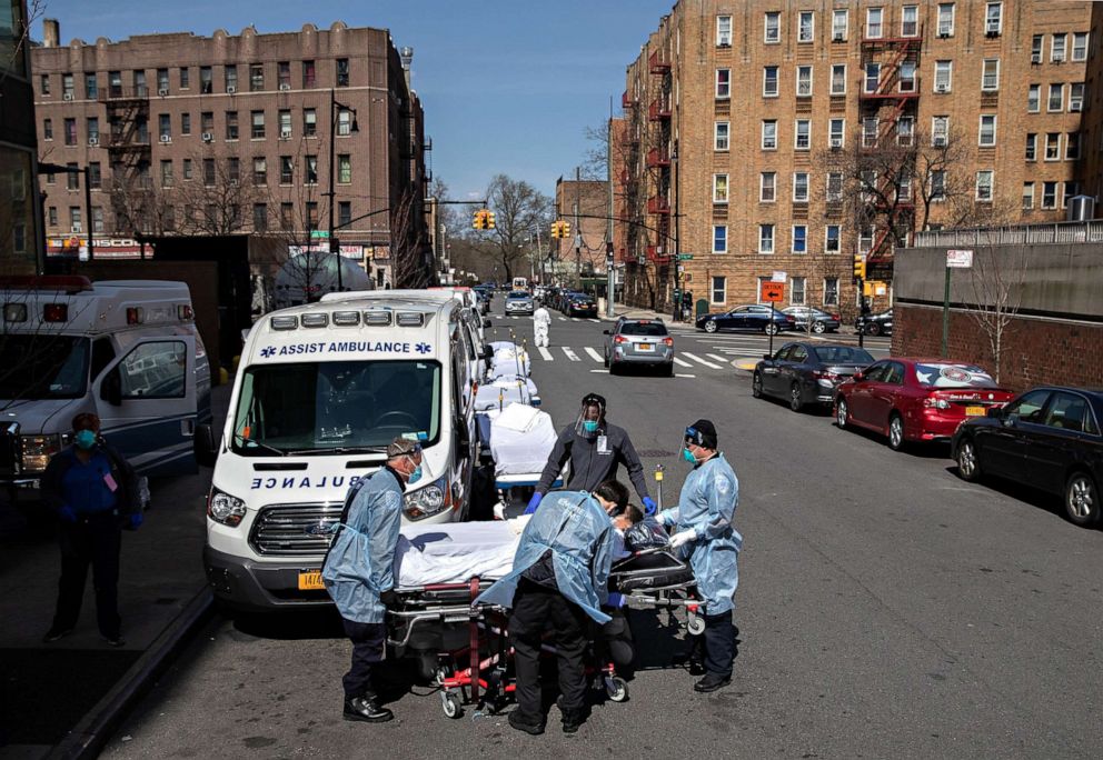 PHOTO: Medics and hospital workers prepare to lift a patient onto a hospital stretcher outside the Montefiore Medical Center Moses Campus, on April 7, 2020, in the Bronx borough of New York City.