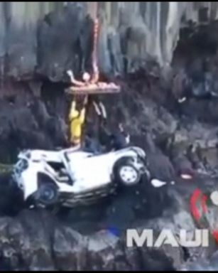 Rescuers are seen pulling the woman out of the wreckage. 