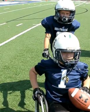 VIDEO: Born with spina bifida, fifth grader Gabe Mangus became a teammate when his school's football team pushed him onto the field and into the end zone.