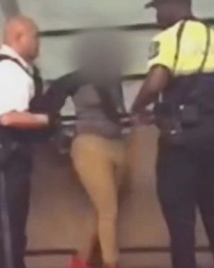 VIDEO: Bystander video shows an officer tripping a woman after she refused to sit.