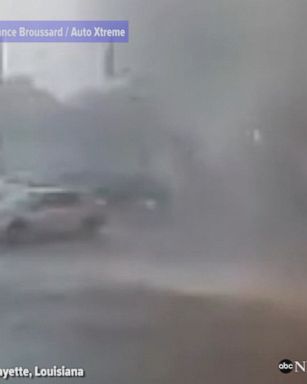 Surveillance video outside a car repair shop in Lafayette, Louisiana shows a small twister touching down and flipping a parked car.