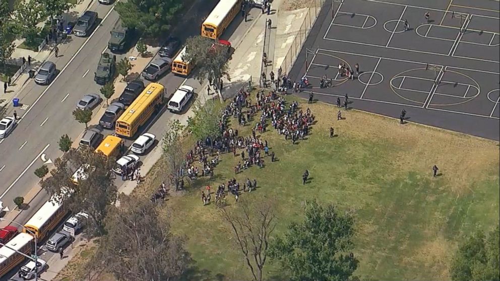 PHOTO: Helicopter footage shows students gathered outside North Park Elementary School in San Bernandino, California following a shooting, April 10.2017.