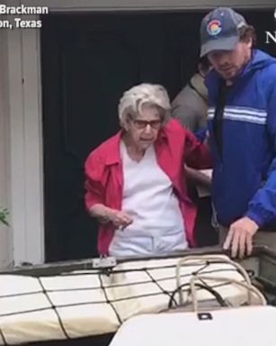 This incredible video shows a man rescuing an elderly woman from flooding in Houston, Texas.