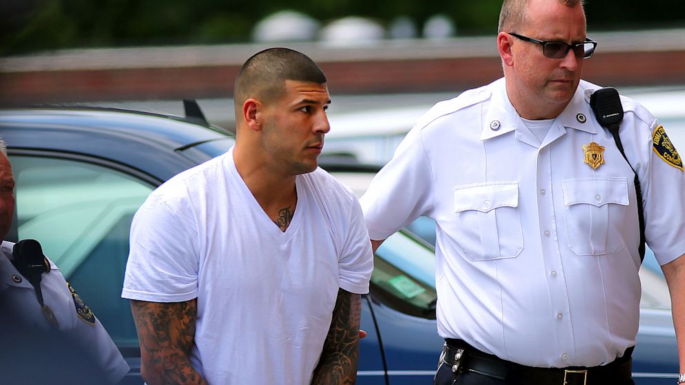 Former New England Patriots player Aaron Hernandez is brought into Attleboro District Court, where Hernandez was charged with murder and five illegal firearms charges in relation to last week's slaying of Odin Lloyd. 