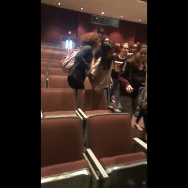 Students appear to be calmly leaving an auditorium in Parkland, Florida.