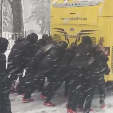 VIDEO: Women's basketball team pushes bus stuck in snow