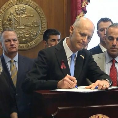 The governor signed the bill nearly a month after 17 people were killed.