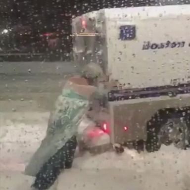 VIDEO: A man dressed as Queen Elsa from "Frozen" helped free a Boston police vehicle from snow. 