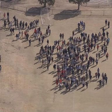 The Columbine students who walked out at 10 a.m. local time today gathered on the school's soccer fields with red, white and blue balloons.