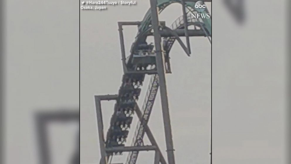 Roller coaster stalls with riders hanging