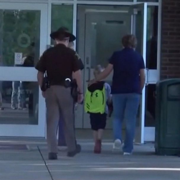 Video Boy gets police escort to school after officer dad's death - ABC News