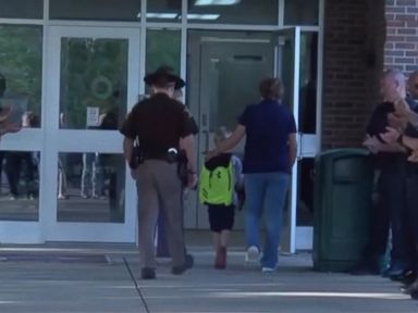 WATCH: Boy gets police escort to school after officer dad's death
