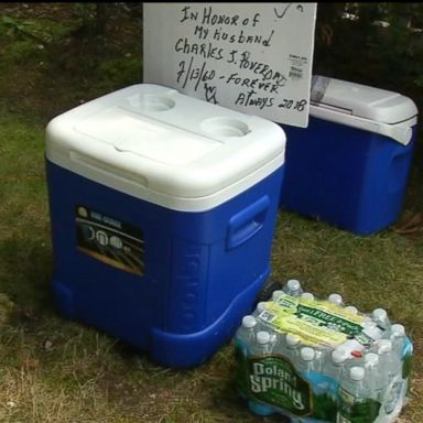 VIDEO: For eight years Charlie Poveromo filled his cooler with drinking water to help passersby deal with the brutal heat. Now, his wife is carrying on his legacy.