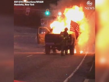 WATCH: Firefighters praised for saving flag from burning truck
