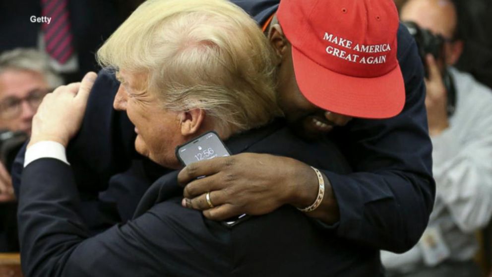 Kanye West hugs President Trump and ABC News' Johnathan Karl in the Oval Office ...