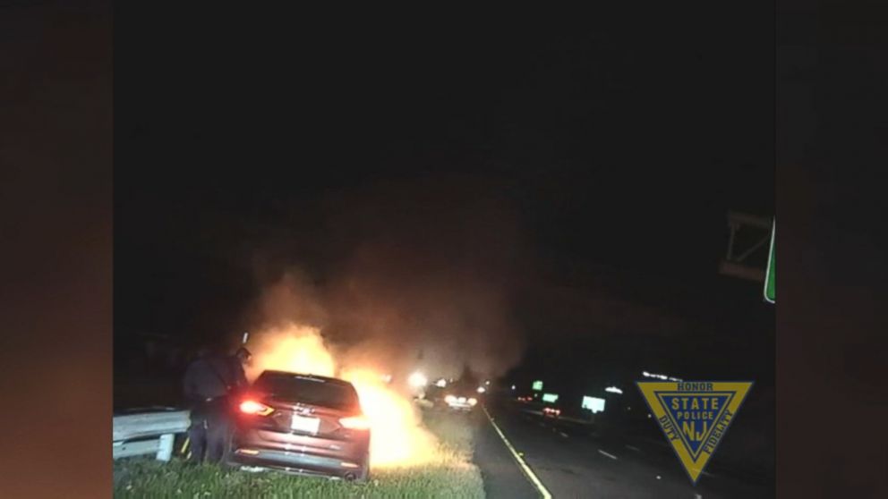 Two troopers rescued the man moments before his car became fully engulfed in flames.