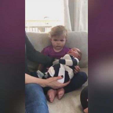 VIDEO: This toddler doesn't appear to be too thrilled to meet her baby brother, hilariously staring plainly into the camera.