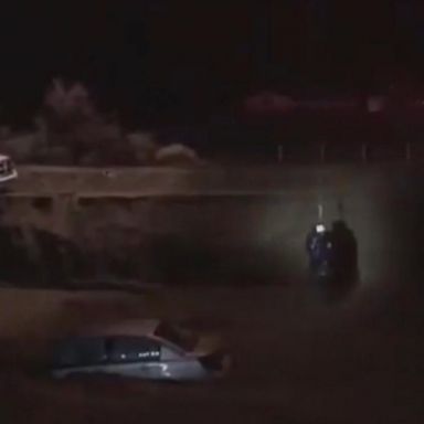 VIDEO: San Bernardino police perform a dramatic swift water rescue of a hypothermic man trapped in his car surrounded by rushing flood waters.