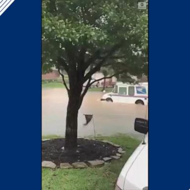 This US Postal Service driver was able to safely maneuver through rising floodwaters as heavy rain batters the Houston area.