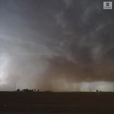  A tornado touched down in Tahoka, Texas, darkening the sky with ominous storm clouds, damaging roads, trees and downing power lines.