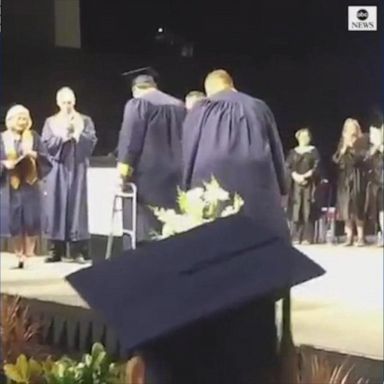 PHOTO: High school athlete left paralyzed by car crash gets a standing ovation as he walks across the stage at his graduation ceremony. 