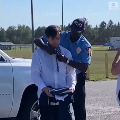 A Georgia police officer took a break directing traffic to help a teenager fix his tie for his high school graduation.