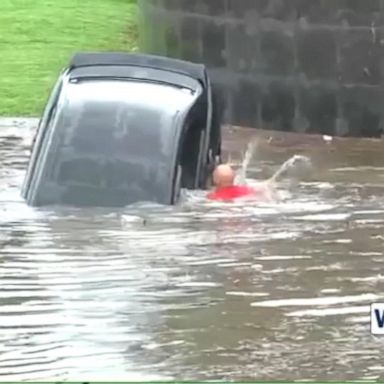 Firefighters save woman from car during flood