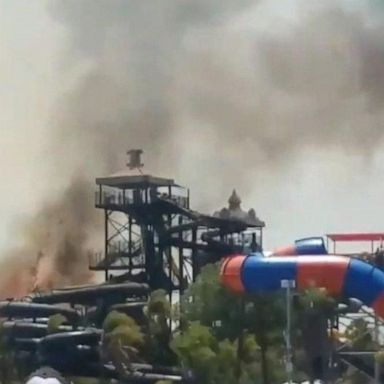 VIDEO: Wildfire smoke and flames force theme park evacuation