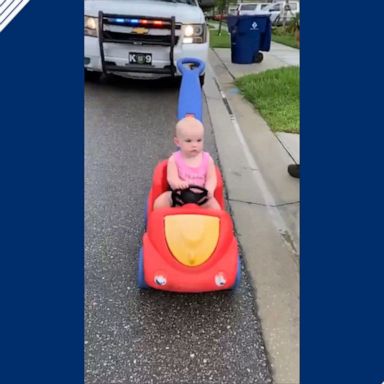 Toddler catches lucky break from cop dad