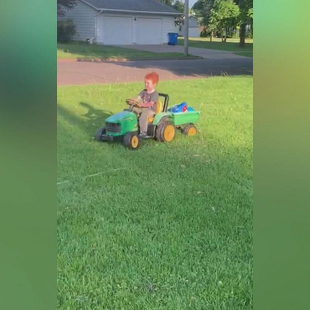 little boy riding john deere tractor