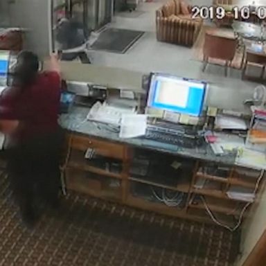 VIDEO: Hotel clerk grabs gun from robbery suspect