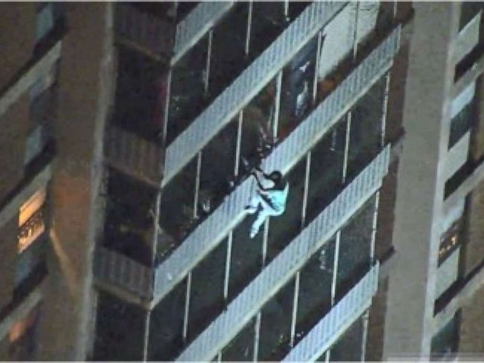 PHOTO: A man is seen climbing down a 19-story high-rise during a fire Thursday night in Philadelphia. He escaped unharmed.