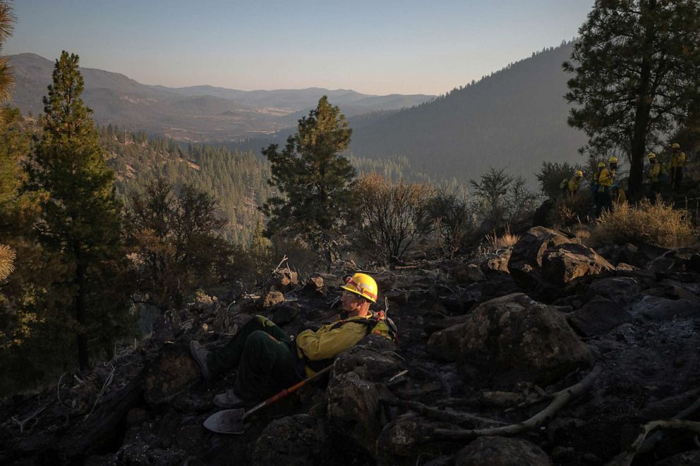 PHOTO: Matthew Tice, an inmate from Warner Creek Correctional Facility, takes a break as he and other inmates who are all working as firefighters help to mop up hotspots from the Brattain Fire in Fremont National Forest near Paisley, Ore., Sept. 20, 2020.