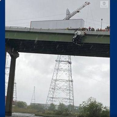 VIDEO: Firefighters rescue man inside truck dangling off bridge