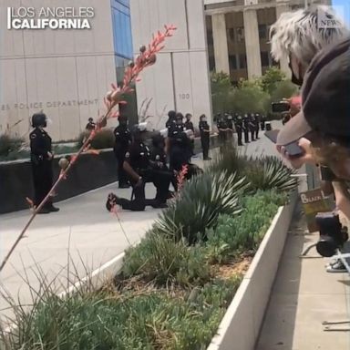 VIDEO: LAPD officers take a knee during protest