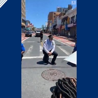 Protesters cheered as the officers kneeled in solidarity in Queens.