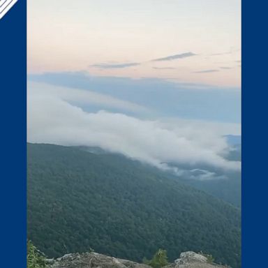 A hiker captured clouds rolling over the Blue Ridge Mountains as the sun rises.