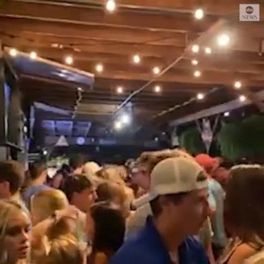 A popular sports bar near the University of South Carolina showed customers not practicing social distancing or wearing masks amid the coronavirus pandemic. 