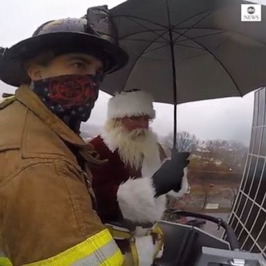 Tennessee firefighters used a service ladder to lift Santa Claus to the hospital's upper floors to give young patients Christmas greetings. 