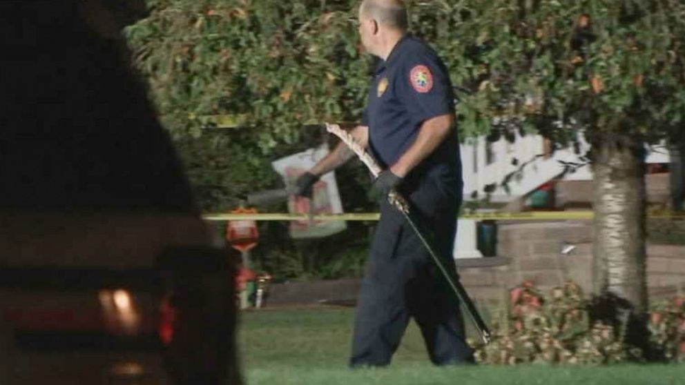 PHOTO: A police officer removes a samurai sword from a Long Island, New York, home after police fatally shot a man who confronted them with the weapon Friday.